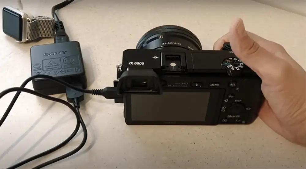 How do you charge a Sony A6000 Camera?